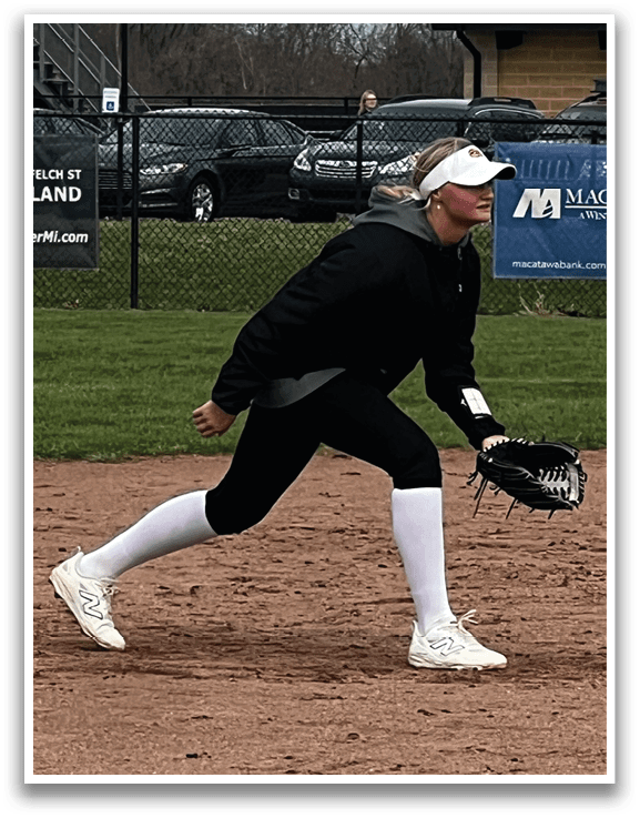A woman in a black and white uniform is playing baseball. AI generated content