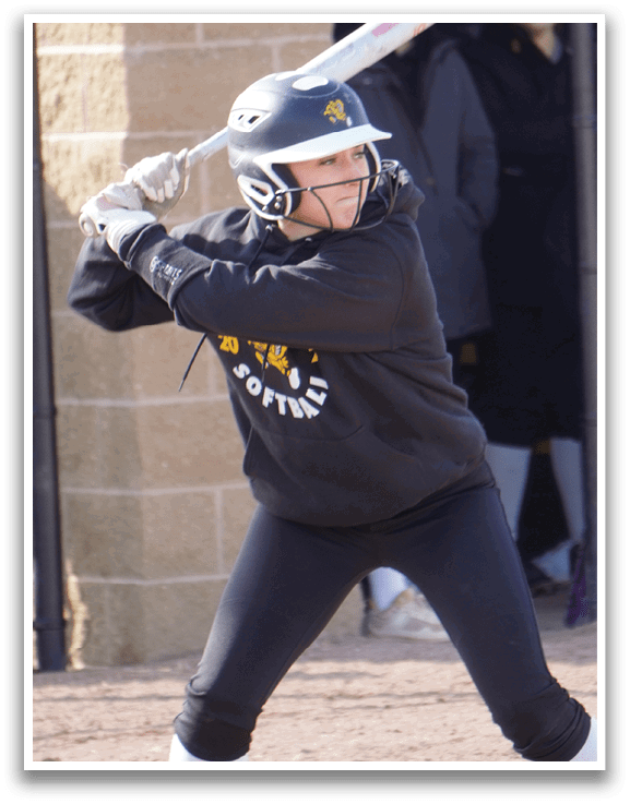 A woman in a black and yellow shirt is swinging a bat at a ball. AI generated content