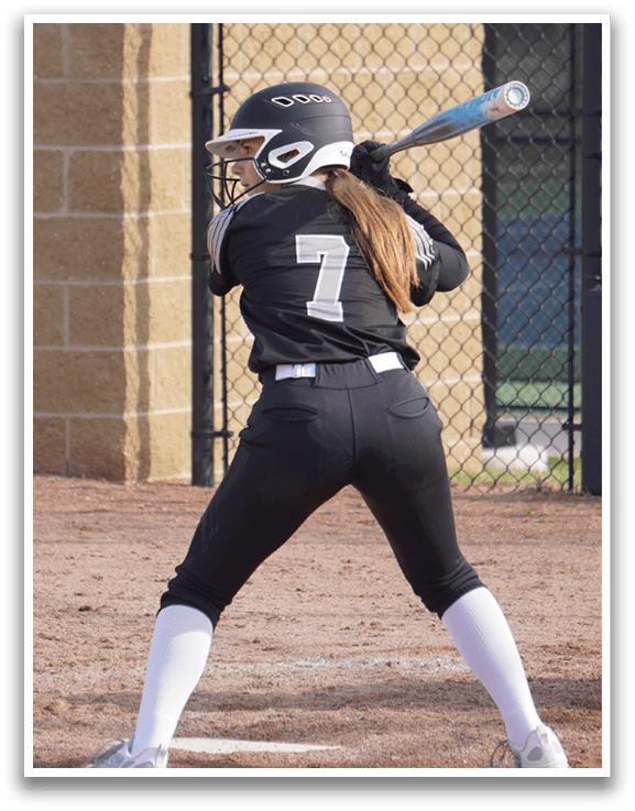 A female baseball player is swinging a bat, attempting to hit a ball. AI generated content