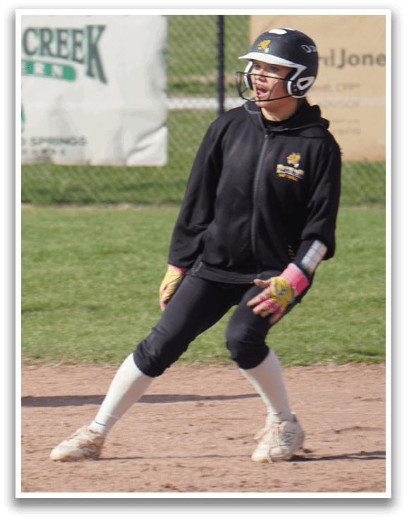 Two female baseball players are on the field, one holding a baseball bat and the other wearing a baseball glove. They are standing next to each other, possibly preparing for a play. AI generated content