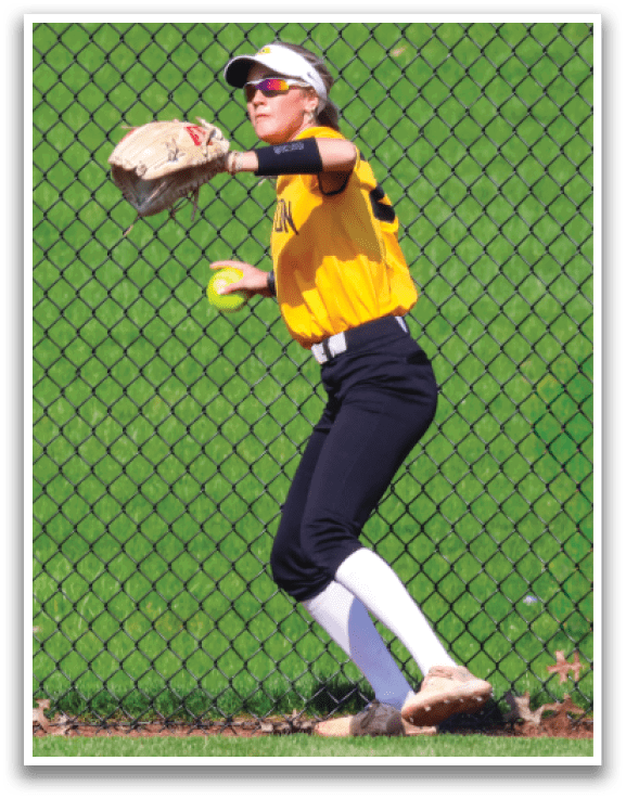 A woman wearing a yellow shirt and black pants is catching a ball. AI generated content