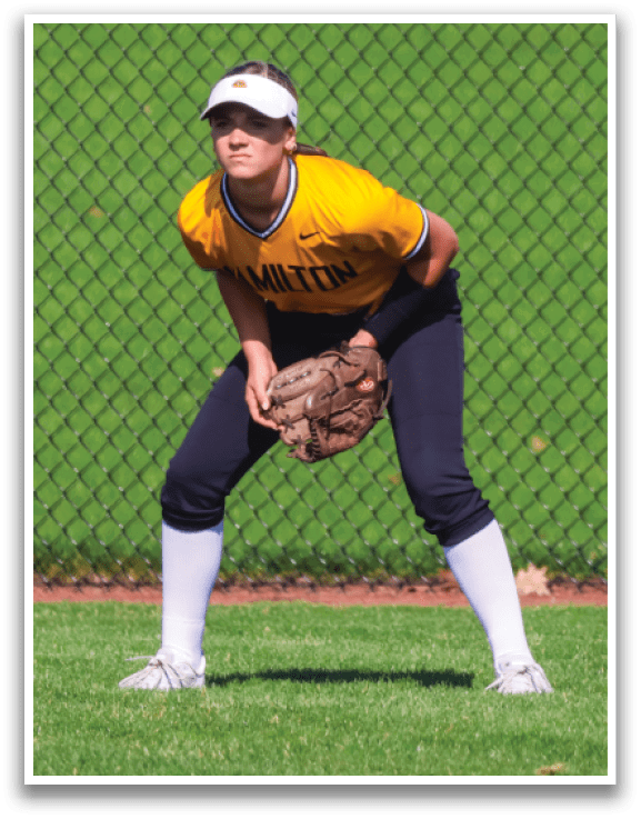 A woman wearing a yellow shirt and black shorts is playing baseball. AI generated content