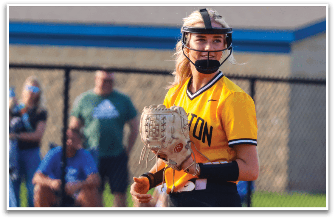A woman wearing a yellow and black shirt and a helmet is holding a catcher's mitt. AI generated content