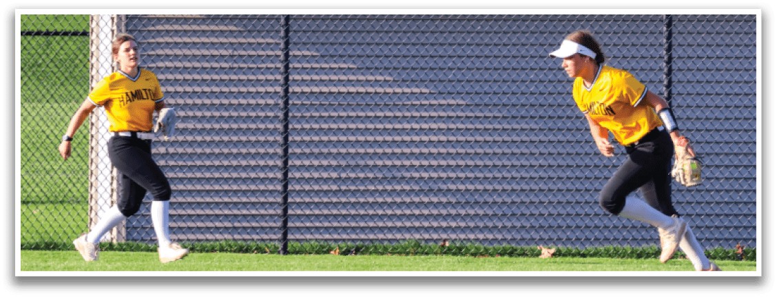 Two girls are playing softball in a field. One girl is running towards the base while the other girl is standing in the outfield. AI generated content