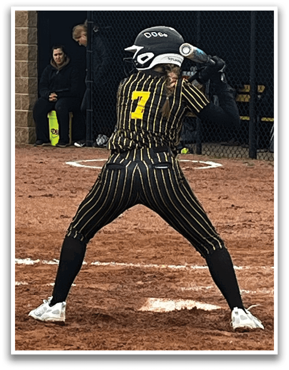 A baseball player is at bat, wearing a black and yellow uniform. AI generated content