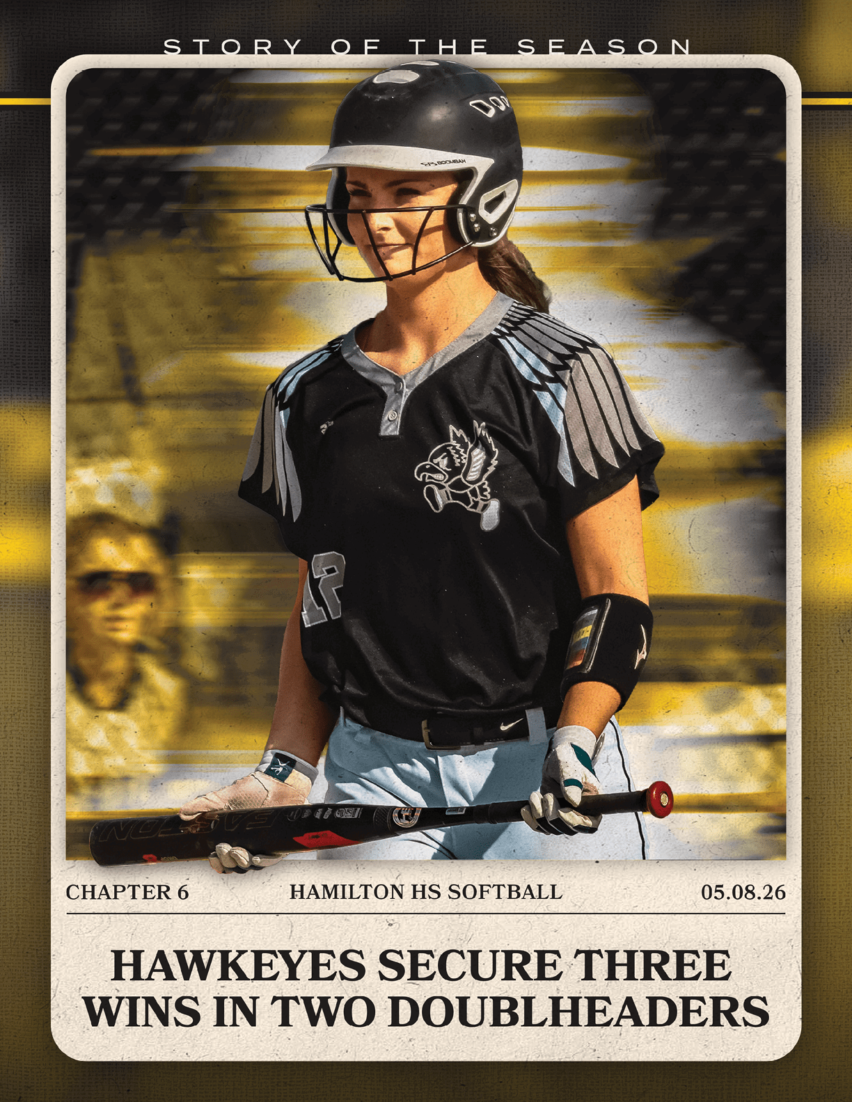 A girl wearing a black and white uniform holding a bat. Description generated by AI