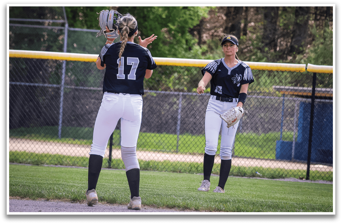 Two girls playing softball. Description generated by AI