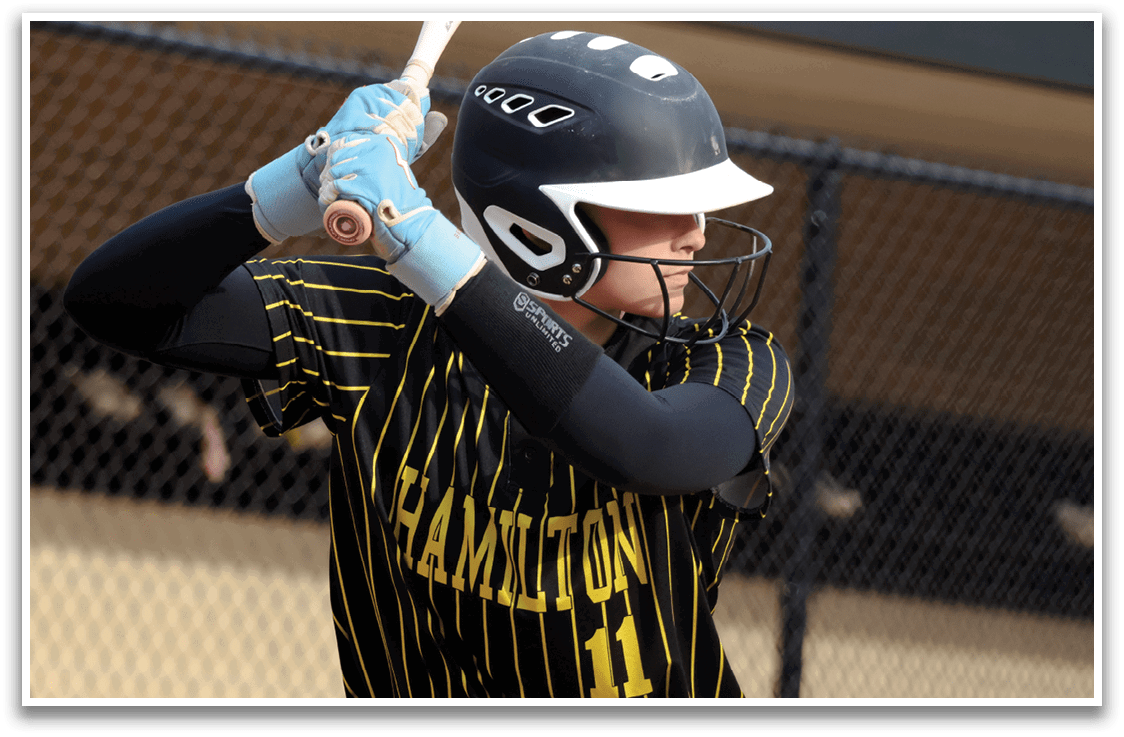 A baseball player wearing a black and yellow jersey and a blue glove. Description generated by AI