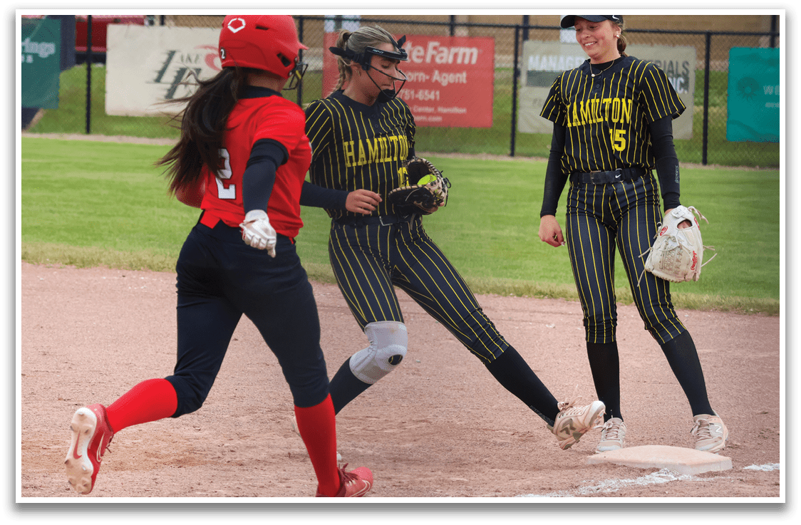 A girl in a red shirt and black pants is running on a baseball field. Description generated by AI