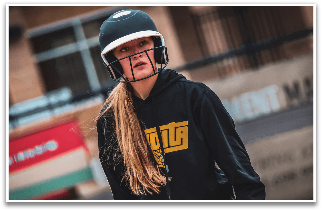 A girl wearing a helmet and a hoodie. Description generated by AI