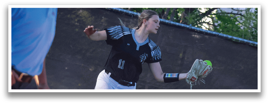 A woman wearing a black and white shirt and white pants is throwing a ball. Description generated by AI