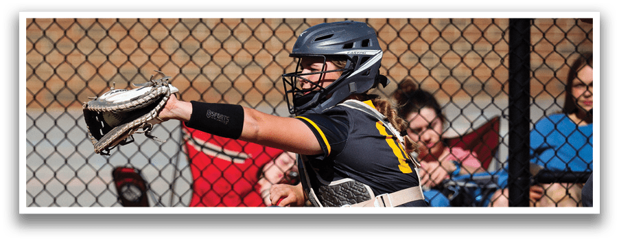 A woman catching a ball in a baseball game. Description generated by AI