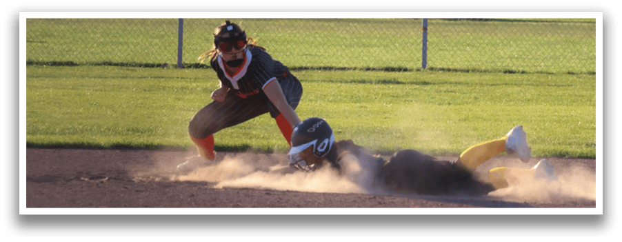A girl slides into a base during a softball game. Description generated by AI