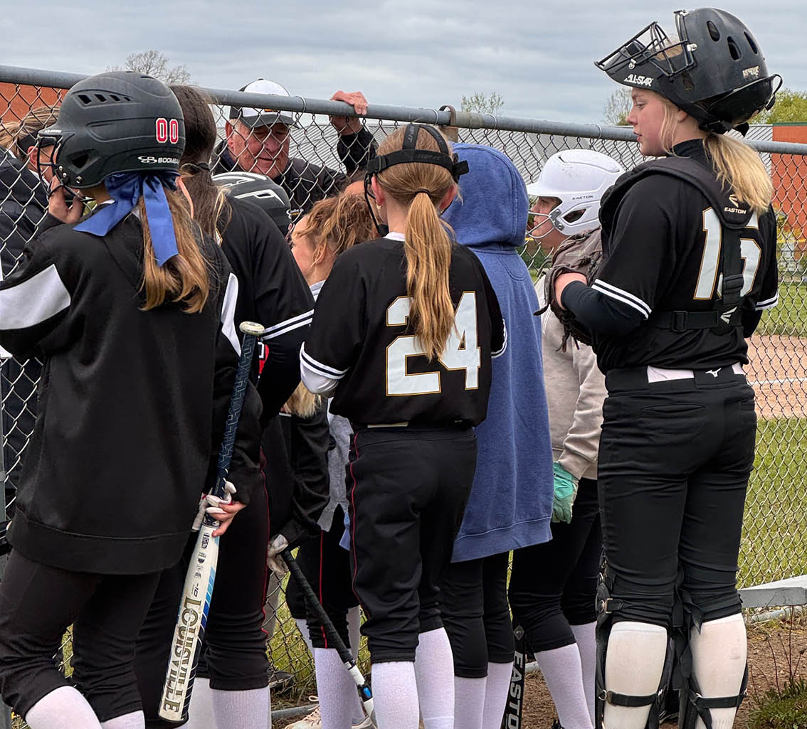 A group of girls wearing black and white uniforms. Description generated by AI