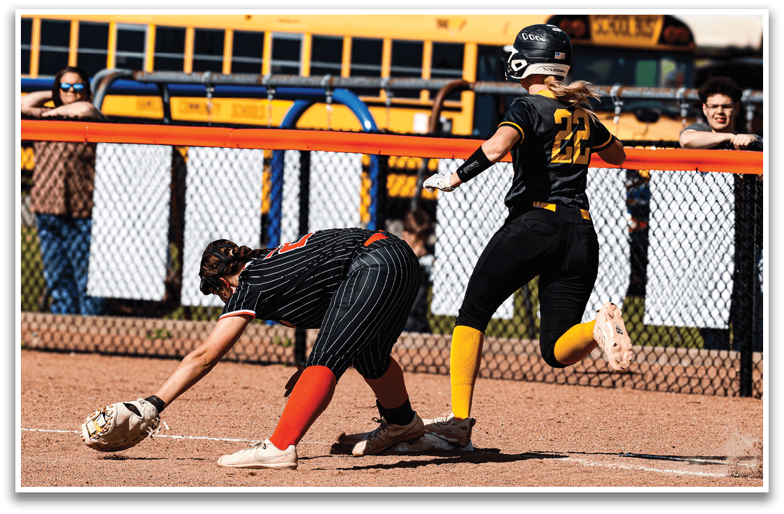 A girl sliding into a base. Description generated by AI