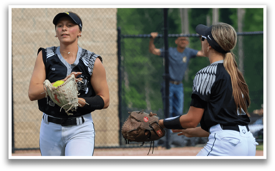 Two female baseball players wearing black and white uniforms. Description generated by AI