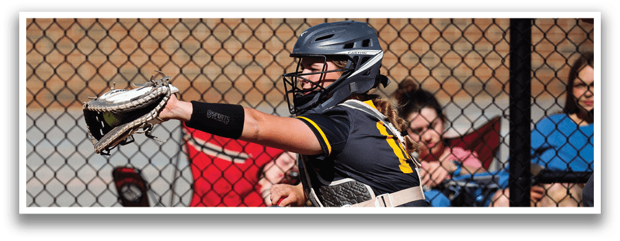 A woman catching a ball in a baseball game. Description generated by AI