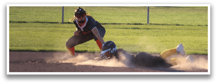 A girl slides into a base during a softball game. Description generated by AI