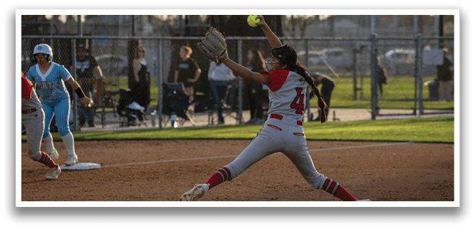 A female baseball player in a red and white uniform is attempting to catch a ball. AI generated content