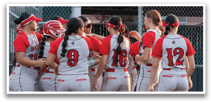 A group of female softball players huddle on the field. AI generated content