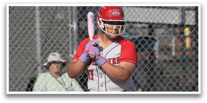 A woman in a red shirt and white pants holding a bat. Description generated by AI