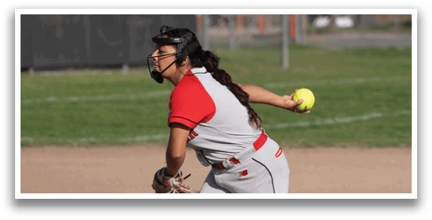 A woman in a red and white uniform is pitching a softball. Description generated by AI