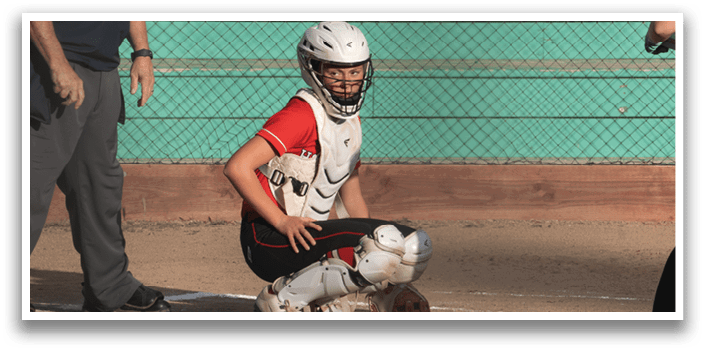 A baseball player is holding a bat and getting ready to hit the ball. Description generated by AI