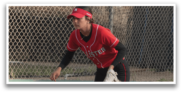 A woman is playing baseball, wearing a red shirt and black shorts. Description generated by AI