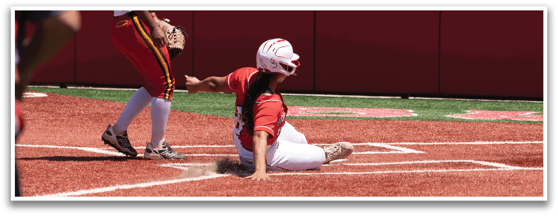 A baseball player slides into home base. Description generated by AI