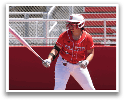 A woman is swinging a bat at a ball. Description generated by AI