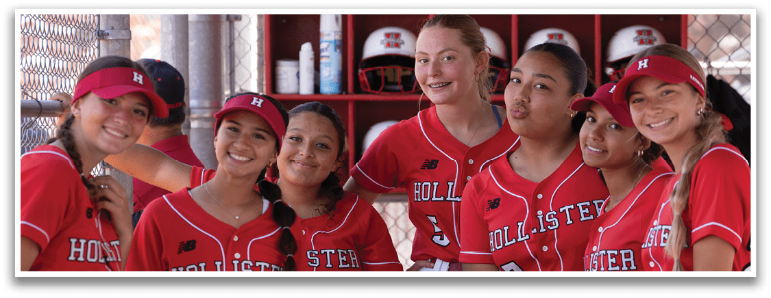 A group of girls wearing red and white uniforms. Description generated by AI