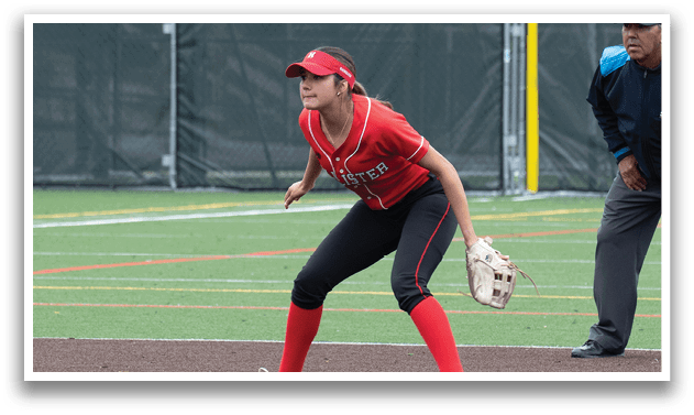A woman wearing a red shirt and black shorts is playing baseball. Description generated by AI