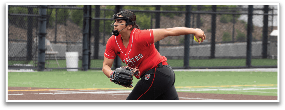 A woman in a red shirt and black pants is pitching a baseball. Description generated by AI