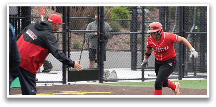 A woman wearing a red shirt and black shorts is running on a baseball field. Description generated by AI