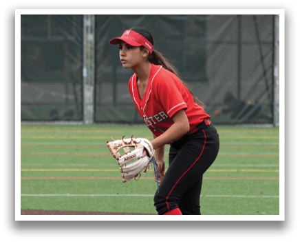 A woman in a red shirt and black shorts is playing baseball. Description generated by AI