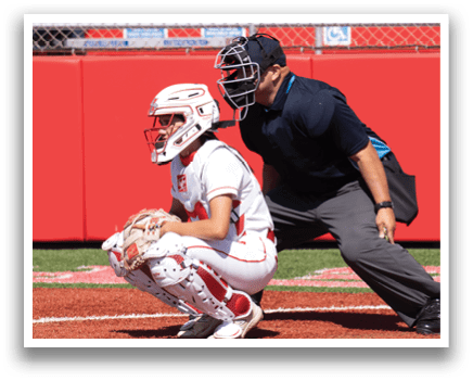 A baseball player is crouching down at home plate. Description generated by AI