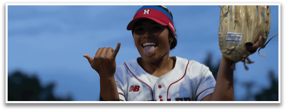 A woman wearing a red and white baseball uniform is holding a catcher's mitt. Description generated by AI