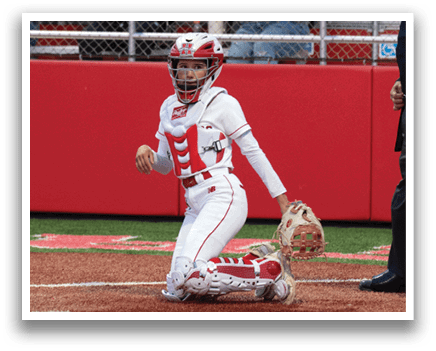 A baseball player is squatting on the field. Description generated by AI
