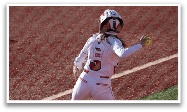 A person wearing a white and red uniform is standing on a baseball field. Description generated by AI