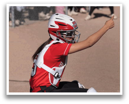 A baseball field with two girls standing on it. Description generated by AI