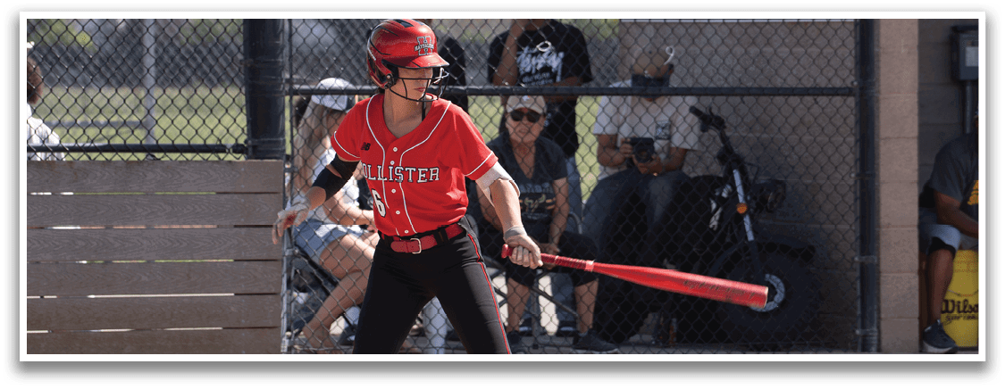 A woman wearing a red and white baseball uniform is holding a catcher's mitt. Description generated by AI