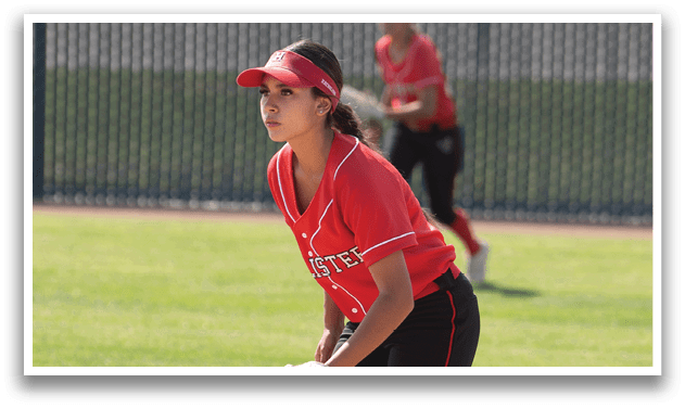 A person wearing a white and red uniform is standing on a baseball field. Description generated by AI