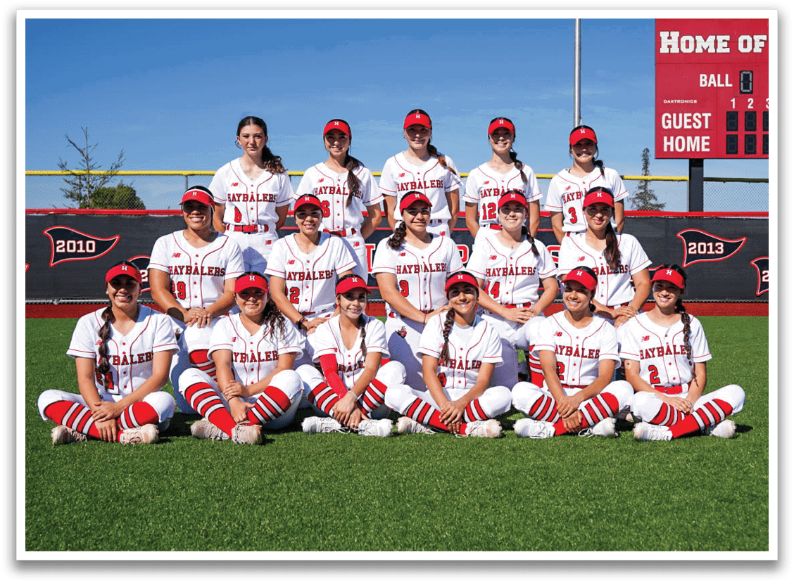 A group of female softball players pose for a picture on a field. AI generated content