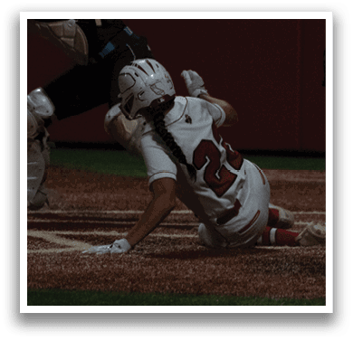 A female baseball player is sliding into home plate while the catcher tries to tag her out. AI generated content