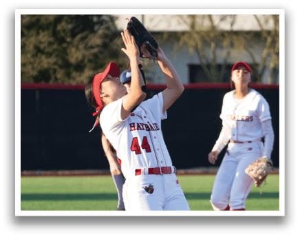 A female baseball player catching a ball in a game. AI generated content