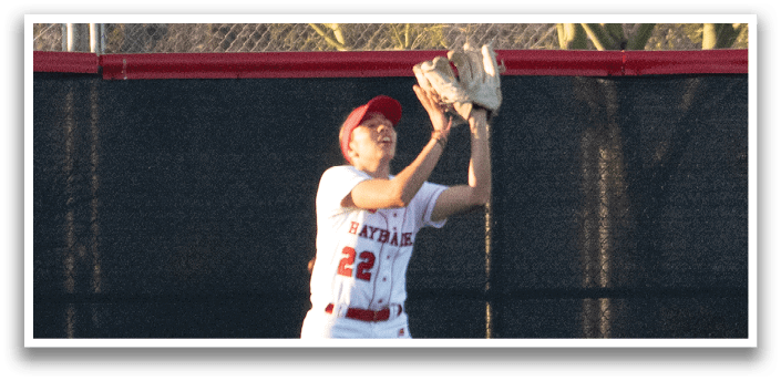 A female baseball player is throwing a ball on a field. AI generated content
