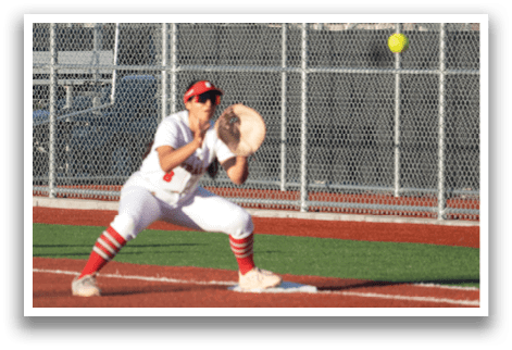A female baseball player catching a ball in front of a fence. AI generated content