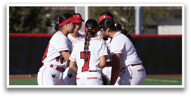 A group of female softball players huddle together on the field. AI generated content