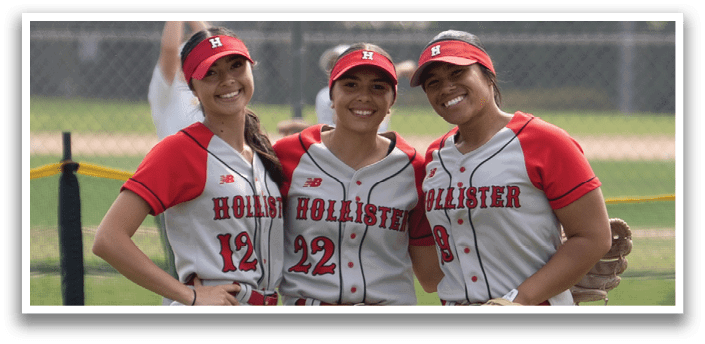 Two female softball players pose for a picture on the field. AI generated content