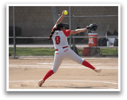 A woman in a white and red uniform is pitching a softball on a field. AI generated content